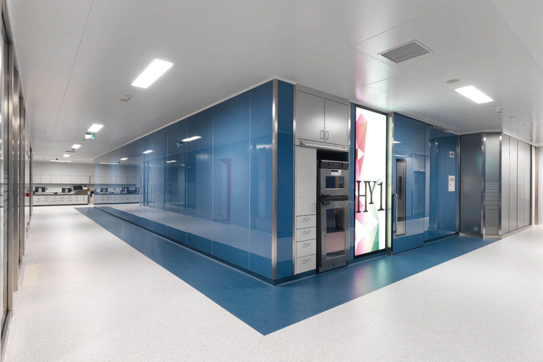 Corridor in the operating area Glass wall system in the operating environment with backlit glass element